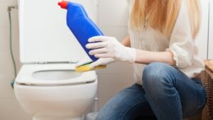 a woman want to clean toilet